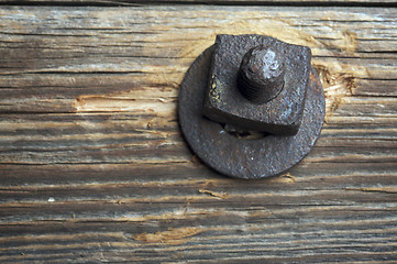 Image showing Antique Rusty Bolt, Washer and Wood