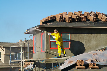 Image showing Construction Worker Pressure Washes 