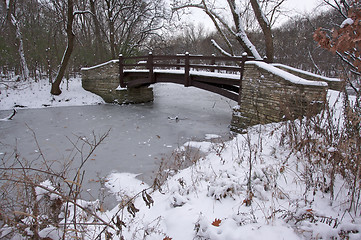 Image showing Beautiful Wooden Bridge Over Frozen Stream