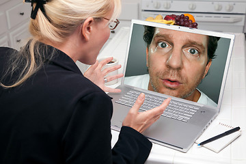 Image showing Excited Woman In Kitchen Using Laptop - Intrusion of Privacy