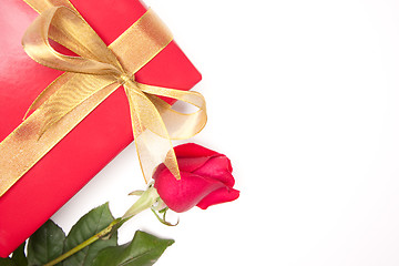 Image showing Gift with Gold Ribbon and Rose on White