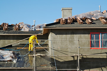 Image showing Construction Worker Pressure Washes 