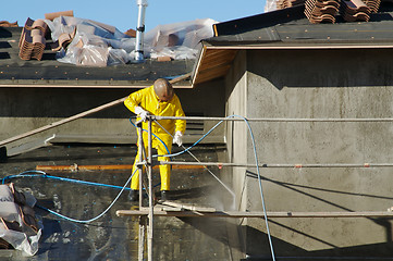 Image showing Construction Worker Pressure Washes 