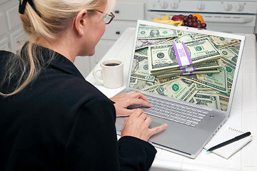 Image showing Woman In Kitchen Using Laptop - Money