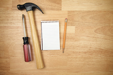 Image showing Pad of Paper, Pencil, Hammer and Screwdriver