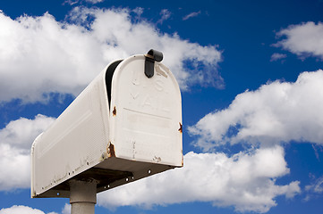 Image showing Weathered Old Mailbox Against Blue Sky and Clouds