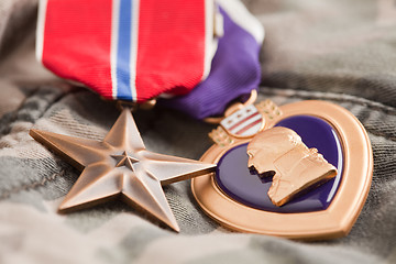 Image showing Bronze and Purple Heart Medals on Camouflage Material