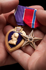 Image showing Man Holding Purple Heart and Bronze War Medals