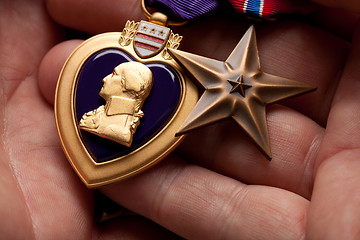 Image showing Man Holding Purple Heart and Bronze War Medals