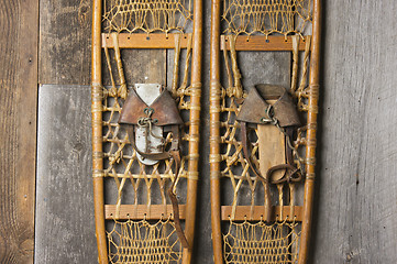 Image showing Antique Snowshoes on Rustic Cabin Wall