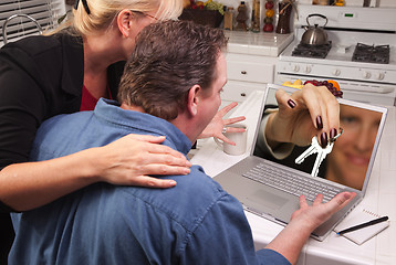 Image showing Couple In Kitchen Using Laptop - House Keys