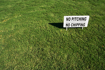 Image showing No Pitching or Chipping Sign on Lush Green Grass