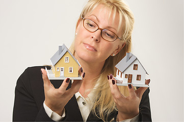 Image showing Woman Holding Two Houses