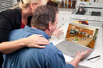 Image showing Couple In Kitchen Using Laptop - Home Improvement