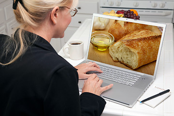 Image showing Woman In Kitchen Using Laptop - Food and Recipes