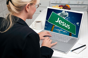 Image showing Woman In Kitchen Using Laptop with Jesus Sign