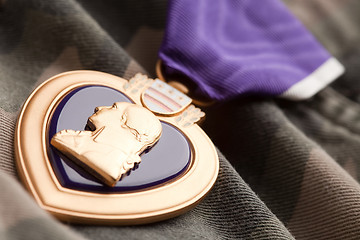 Image showing Purple Heart War Medal on Camouflage Material