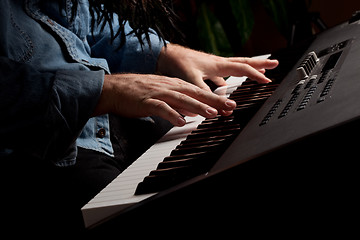 Image showing Male Pianist Performs on the Piano Keyboard