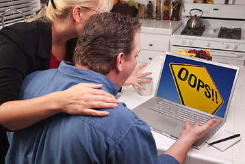 Image showing Couple In Kitchen Using Laptop - Oops! Sign