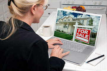 Image showing Woman In Kitchen Using Laptop for Real Estate