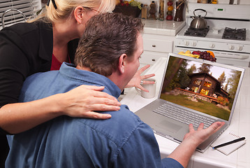 Image showing Couple In Kitchen Using Laptop - Cabin