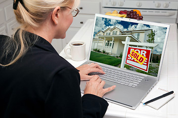 Image showing Woman In Kitchen Using Laptop for Real Estate