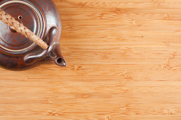 Image showing Tea Pot and Bamboo Textured Surface