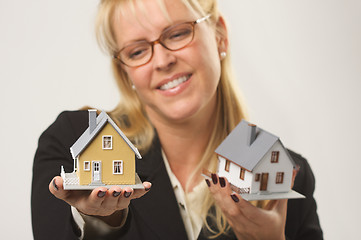 Image showing Woman Holding Two Houses