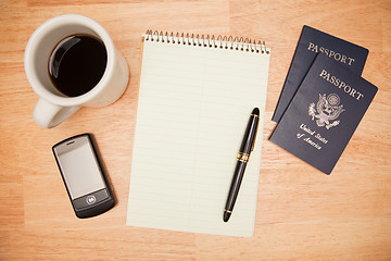 Image showing Overhead Pad, Pen, Passports, Coffee and Cell Phone