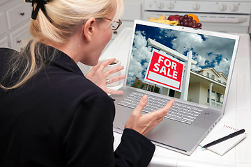 Image showing Excited Woman In Kitchen Using Laptop  - Real Estate Shopping