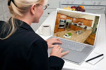 Image showing Woman In Kitchen Using Laptop - Home Improvement