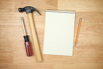 Image showing Pad of Paper, Pencil, Hammer and Screwdriver 