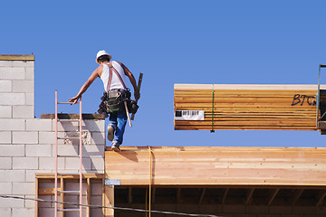 Image showing Carpenter Climbing Up Ladder