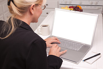 Image showing Woman In Kitchen Using Laptop with Blank Screen