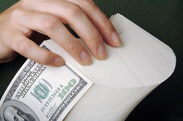 Image showing Woman fanning Large Stack of One Hundred Dollar Dollar Bills