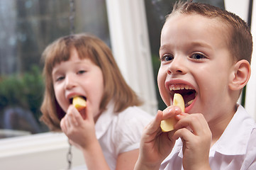 Image showing Sister and Brother Eating an Apple