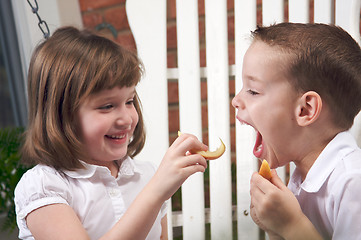 Image showing Sister and Brother Eating an Apple