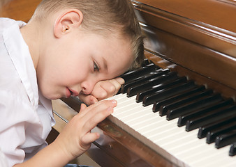 Image showing Young Boy Playing the Piano