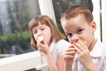 Image showing Sister and Brother Eating an Apple