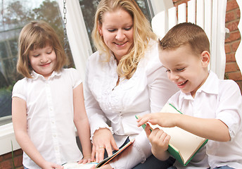 Image showing Young Boy Reads to His Mother and Sister