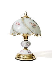 Image showing Table lamp under the glass lampshade with flower pattern isolated