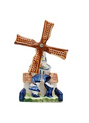 Image showing Porcelain windmill souvenir with two kissing peasants isolated 