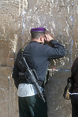 Image showing Israeli soldier praying at the Western Wall in Jerusalem Israel 