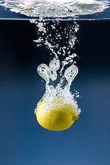 Image showing lemon plunged in blue water