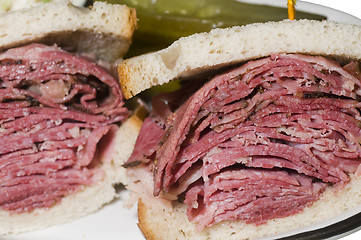 Image showing corned beef pastrami combination sandwich rye bread pickles