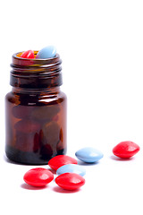 Image showing glass bottle with red and blue pills