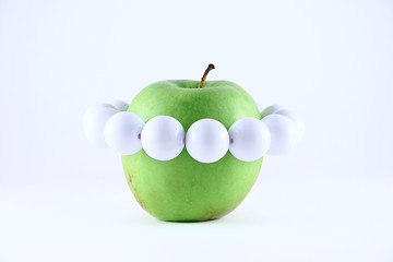 Image showing Green apple with a white beads