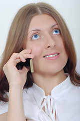 Image showing The smiling girl with a mobile phone