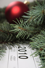 Image showing Calendar for 2010 covered with fur-tree branches