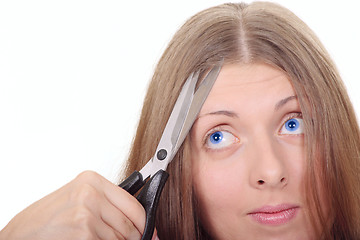 Image showing The nice girl with scissors looking upwards